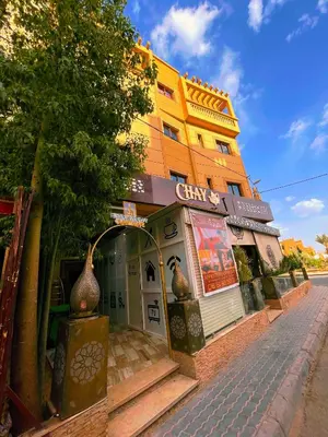 a building with a store on the side of a street at Residence Chay - Appartement de luxe in Ouarzazate