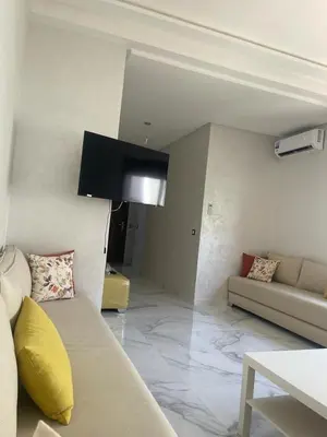 a living room with a couch and a flat screen tv at Private, Air Conditionner and Free Parking in Fès