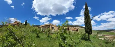 a house on top of a hill in a field at Chalets-Appartements Tourtite in Ifrane