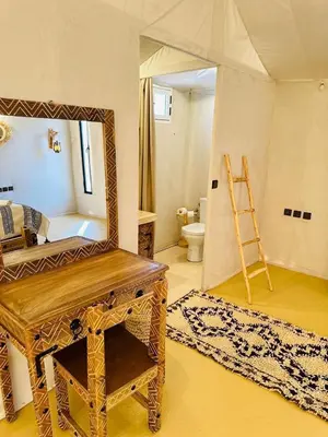 a dressing room with a mirror and a dressing table at Diament Luxury Camp-Sahara Desert Experience in Merzouga in Merzouga