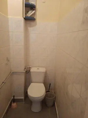 a bathroom with a white toilet in a room at Appartement au centre ville in Beni Mellal