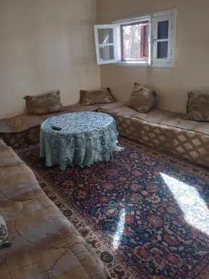 a room with a couch and a table on a rug at Appartement au centre ville in Beni Mellal