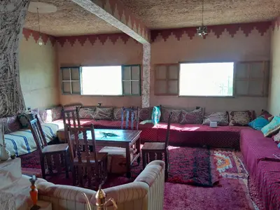 a living room with a couch and a table at Auberge chez hammadi in Zagora