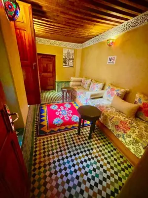 a room with a couch and a table in a room at Riad Dar Lalj Fes in Fès