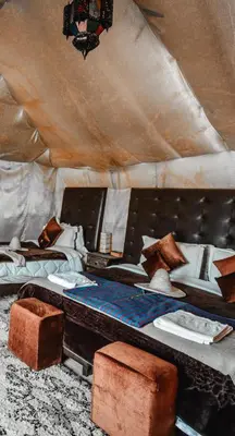 a room with two beds in a tent at Overnight Luxury Camp in Merzouga