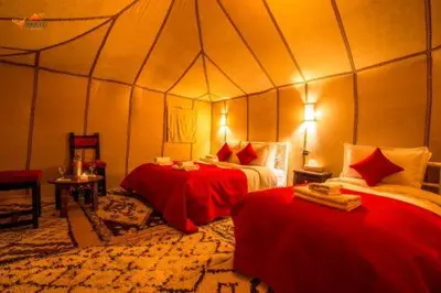 a room with two beds in a tent at Merzouga Luxury Tent in Merzouga