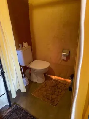 a bathroom with a toilet in a room at Africa Magic Camp in Merzouga