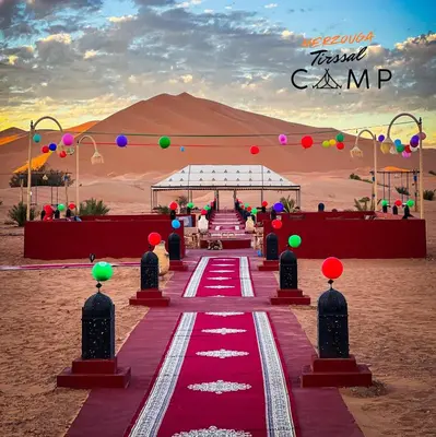 a red carpet for a destination wedding in the desert at Merzouga Tirssal Camp in Merzouga
