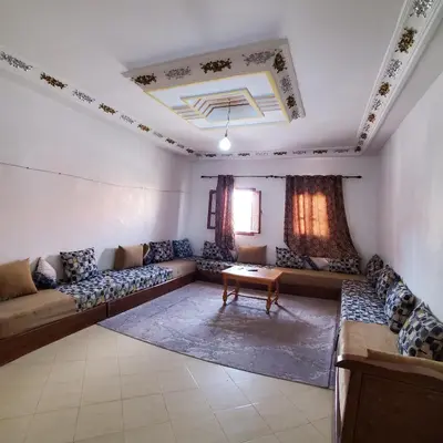 a large living room with couches and a table at Warzazat Apartments in Ouarzazate