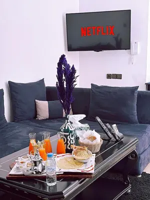 a living room with a couch with a table with food on it at CHAY - Appartements a Ouarzazate in Ouarzazate