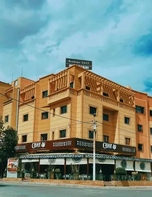 a yellow building with a sign on top of it at CHAY - Appartements a Ouarzazate in Ouarzazate