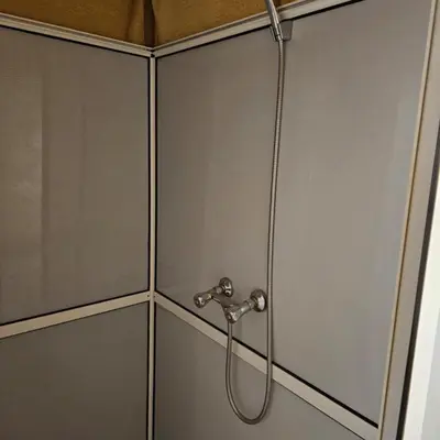 a shower in a bathroom with a hose at abja luxury camp in Merzouga