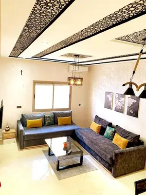 a living room with a couch and a table at Appartement calme top in Fès