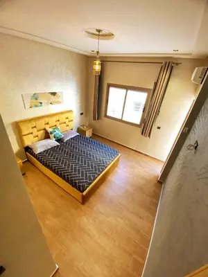 a bedroom with a large bed in a room at Appartement calme top in Fès