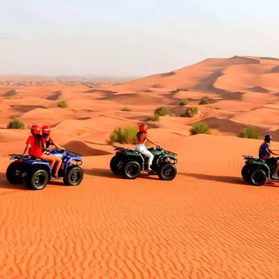 a group of people riding on atvs in the desert at Sahara Family Luxury Camp in Merzouga