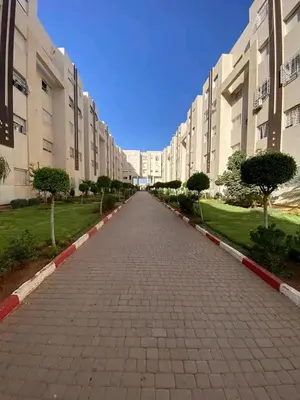 an empty street in front of a large building at طريق صفرو قرب المستشفى الجامعي و قرب مستشفي أكديطال in Fès