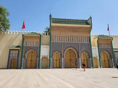 a large building with large doors and a person standing in front at Appartement Centre Ville - ATLAS in Fès