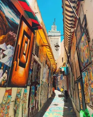 an alley with paintings on the side of a building at Nabiloc Apart Hotel - Centre Ville in Fès