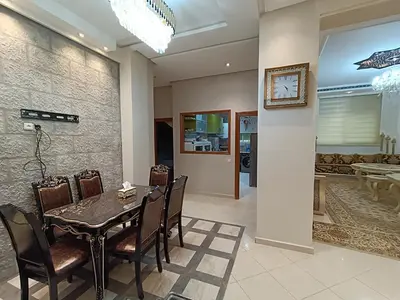 a dining room with a table and chairs at Appartement a Meknès-Hamria in Meknès