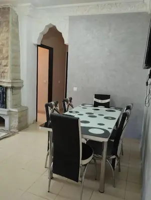 a dining room with a table and chairs at maison soleil in Ifrane