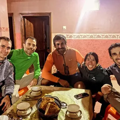 a group of people sitting around a table at gîte taghia ahansal in Taghia