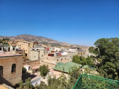 a view of a city with mountains in the background at Dar Zarbtana Chambre Hiba in Fès