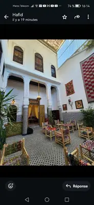 a picture of a living room with tables and chairs at Dar Zarbtana Chambre RADIA in Fès