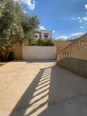 a shadow of a fence next to a driveway at Apparemment familiale 110 m2 in MeknèsKatine