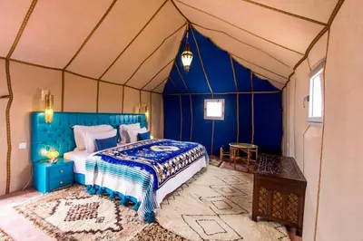 a bedroom with a bed in a tent at Anir Luxury Camp - Gites et Tentes de Luxe in Merzouga