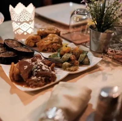 a table with two plates of food on it at Merzouga Sardegna Luxury Camp in Merzouga
