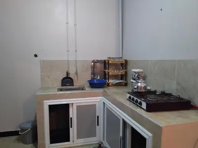 a kitchen with a stove and a counter top at Appartement Chez issmail in Tinerhir