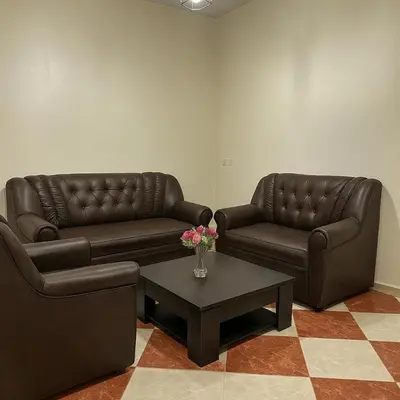 two leather couches and a coffee table in a living room at residence kawtar in Meknès