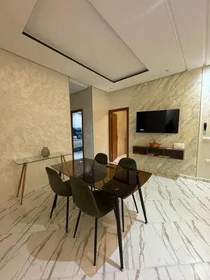 a dining room with a glass table and chairs at Luxe Escape in Fès