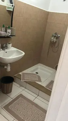 a bathroom with a shower and a sink and a tub at واد فاس طريق مكناس تجزئة البركه قرب طريق الجامعه المتوسطه لاغوميد in Fès