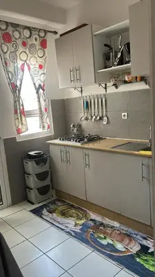 a kitchen with white cabinets and a window at واد فاس طريق مكناس تجزئة البركه قرب طريق الجامعه المتوسطه لاغوميد in Fès