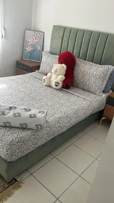 two stuffed animals are sitting on a bed at واد فاس in Fès