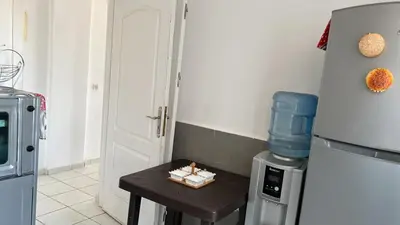 a small table in a kitchen with a refrigerator at واد فاس in Fès