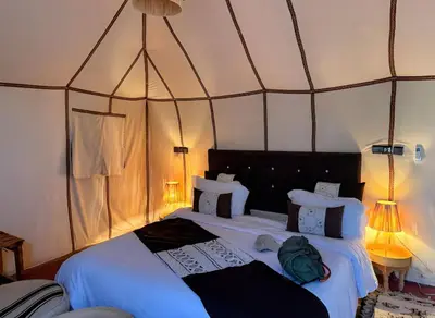 a bedroom with two beds in a tent at Layali Luxury Desert Camp in Merzouga