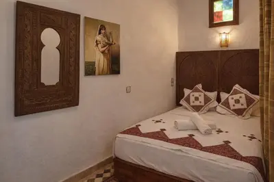 a bedroom with a bed and a picture of a woman at Riad rayhane fez in Fès