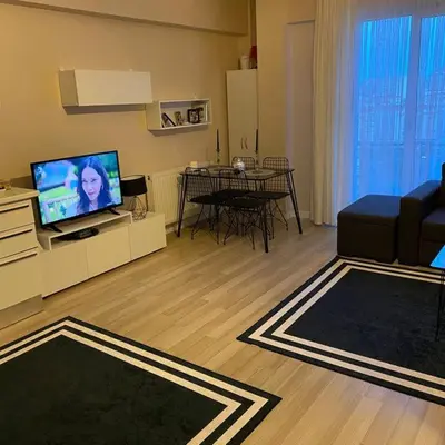 a living room with a couch and a television at aLO MARRAKECH in Kasba Aït Youdi