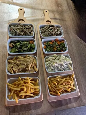 four plastic containers filled with different types of food at Bel appartement familial au centre ville in El Kelaa des Srarhna