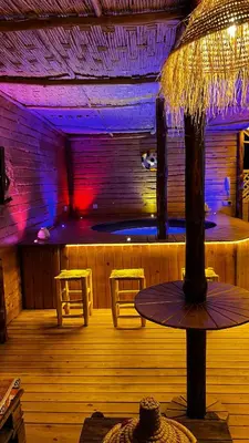 a bar with a table and two stools in a room at Oasis deluxe in Fès