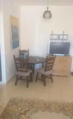 a dining room with a table and two chairs at Vue Neige et Forêt Ifrane bien au chaud 3 pieces in Ifrane