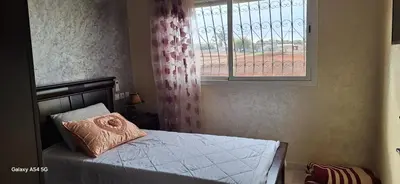 a bedroom with a bed with a pillow and a window at Fes Magic Apartment - With Swimming pool in Fès