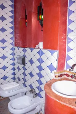 a bathroom with a toilet and a sink in it at Hotel Ksar Kaissar in Kalaat MGouna