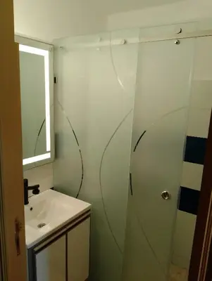 a bathroom with a shower and a sink at Appartement Fadila in Fès