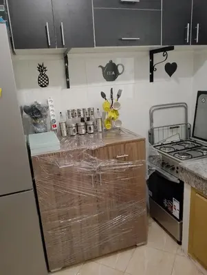 a kitchen with a counter with plastic wrap on it at Appartement Fadila in Fès