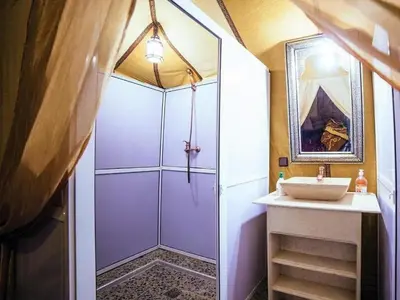a bathroom with a shower and a sink at Soul Dunes Luxury Camp in Merzouga