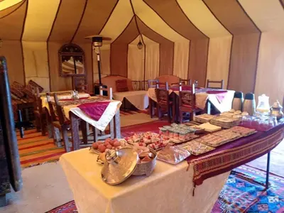 a table with food on it in a tent at Diamond luxury camp in Merzouga