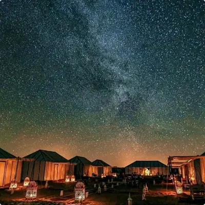 a starry night with a milky way in the sky at Merzouga Spectacular Luxury Camp in Merzouga